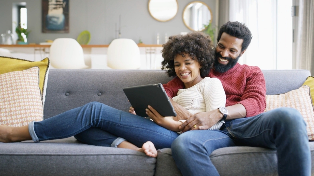 Male and female couple using tablet device